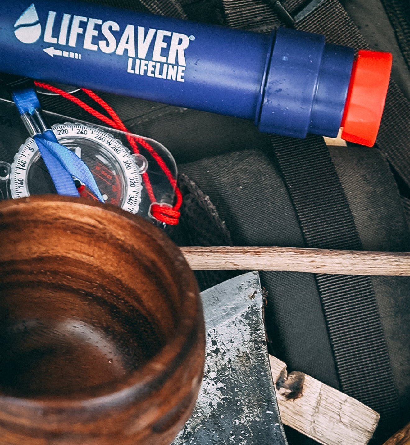 Lifesaver Lifeline water filter on a camping gear background
